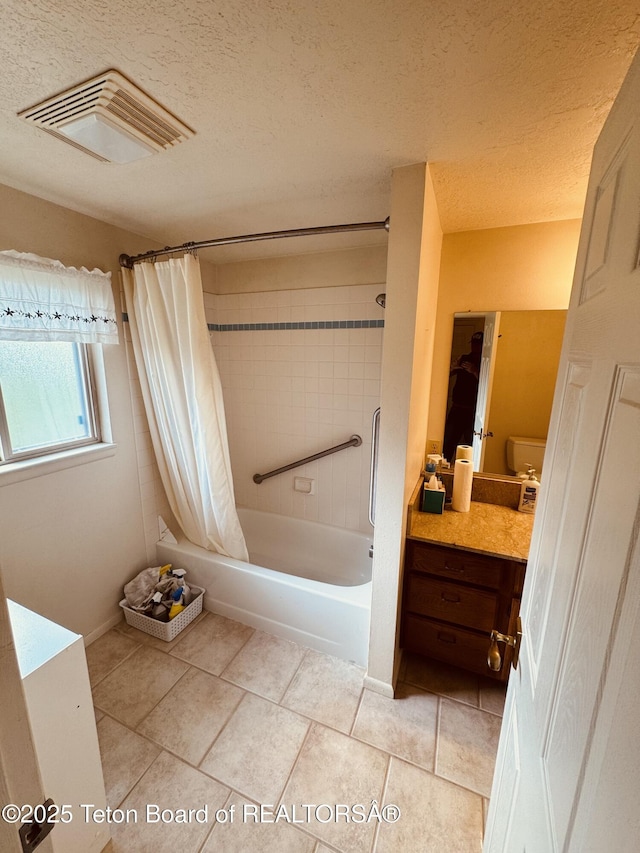 144 Blue Lake Cir, Alpine, WY 83128 - bathroom featuring shower / bath combo with shower curtain, vanity, tile patterned flooring, and a textured ceiling