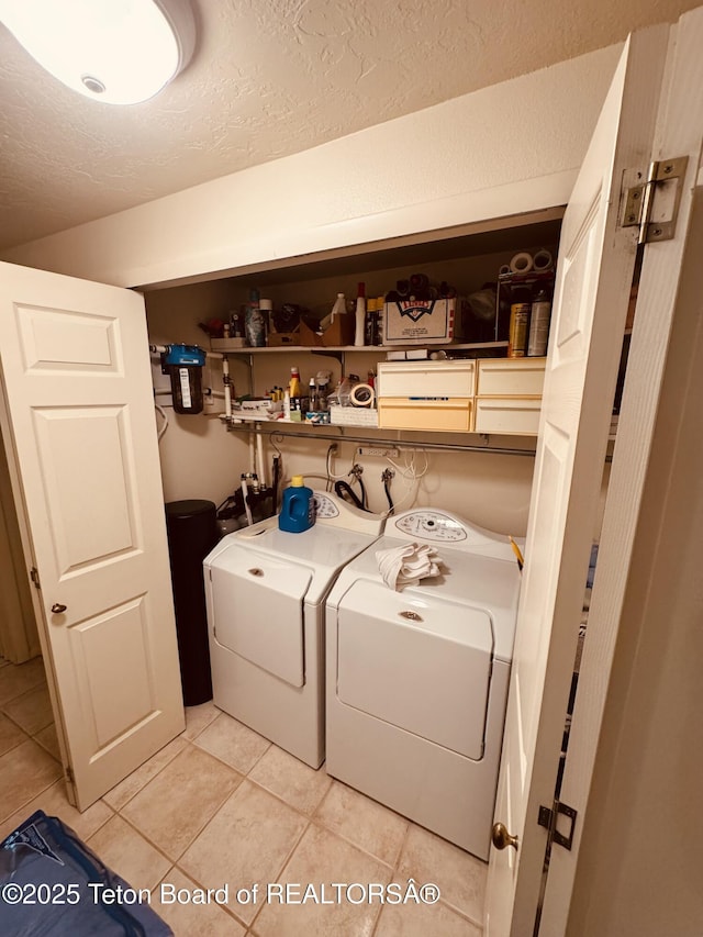 144 Blue Lake Cir, Alpine, WY 83128 - laundry room with a textured ceiling, separate washer and dryer, and light tile patterned floors