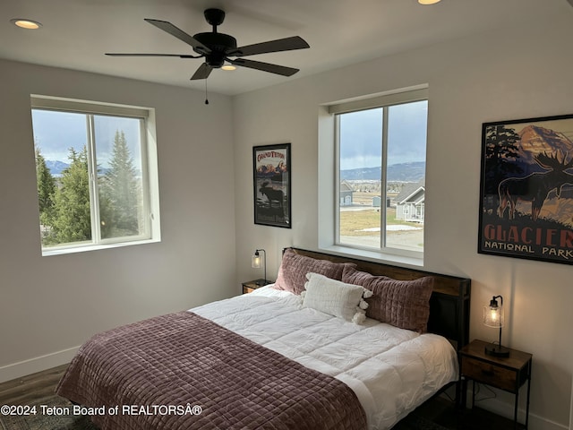 241 Cedar Creek Dr, Star Valley Ranch, WY 83127 - bedroom with wood finished floors, recessed lighting, a ceiling fan, and a mountain view