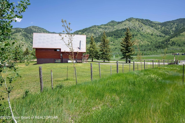 11 E St, Star Valley Ranch, WY 83127 - view of yard with a mountain view, an outdoor structure, an outbuilding, and a view of rural / pastoral area