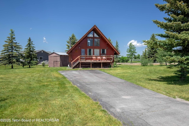 11 E St, Star Valley Ranch, WY 83127 - chalet / cabin featuring a wooden deck, a storage unit, and a front lawn