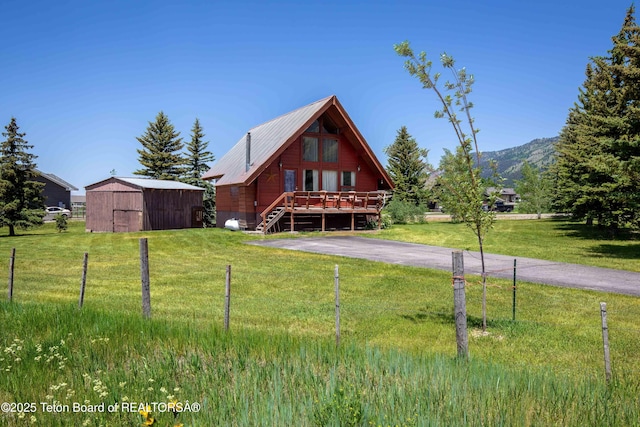 11 E St, Star Valley Ranch, WY 83127 - log cabin with a shed, a deck, a front yard, and a metal roof