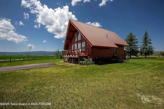11 E St, Star Valley Ranch, WY 83127 - view of property exterior featuring a deck with mountain view, a rural view, and a metal roof