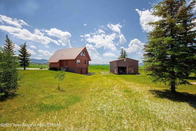11 E St, Star Valley Ranch, WY 83127 - view of green lawn featuring an outbuilding, a pole building, and a garage