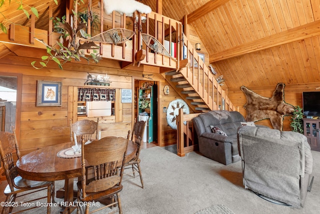 11 E St, Star Valley Ranch, WY 83127 - carpeted dining area featuring wooden walls, a wood ceiling with exposed beams, stairs, and high vaulted ceiling