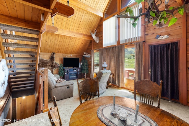 11 E St, Star Valley Ranch, WY 83127 - living room with carpet floors, a wood ceiling with exposed beams, wood walls, and high vaulted ceiling