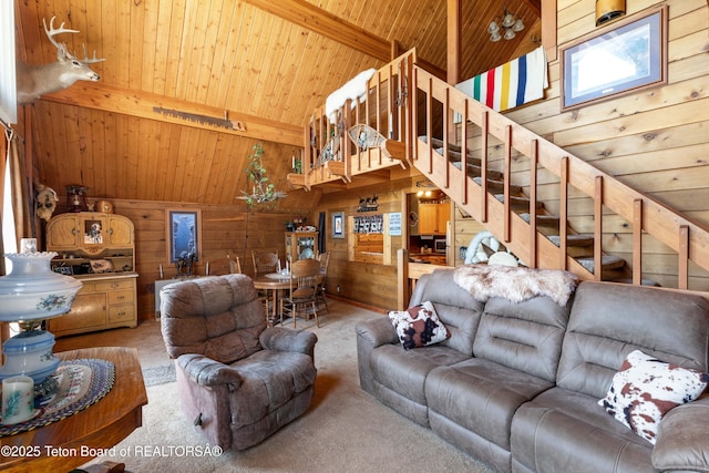 11 E St, Star Valley Ranch, WY 83127 - carpeted living room with a wood ceiling with exposed beams, wood walls, high vaulted ceiling, and stairs