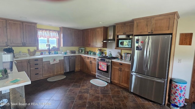 15 E Badger Trl, Pinedale, WY 82941 - kitchen with stainless steel appliances, wall chimney exhaust hood, light countertops, brown cabinets, and recessed lighting