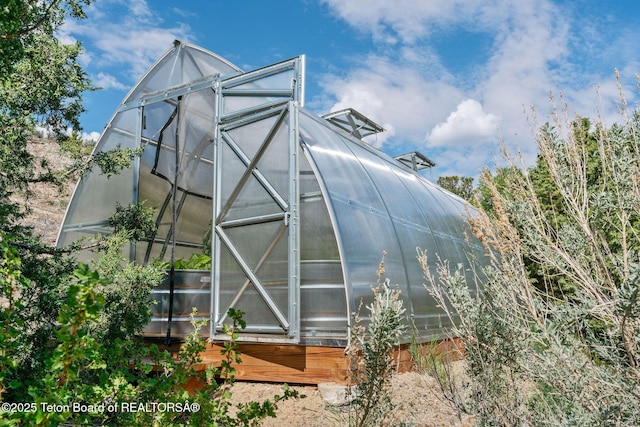 53 Schenck Ln, Dubois, WY 82513 - rear view of house with a greenhouse and an outdoor structure