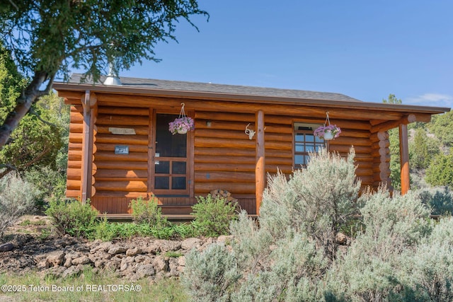 53 Schenck Ln, Dubois, WY 82513 - view of front of property with log siding and a shingled roof