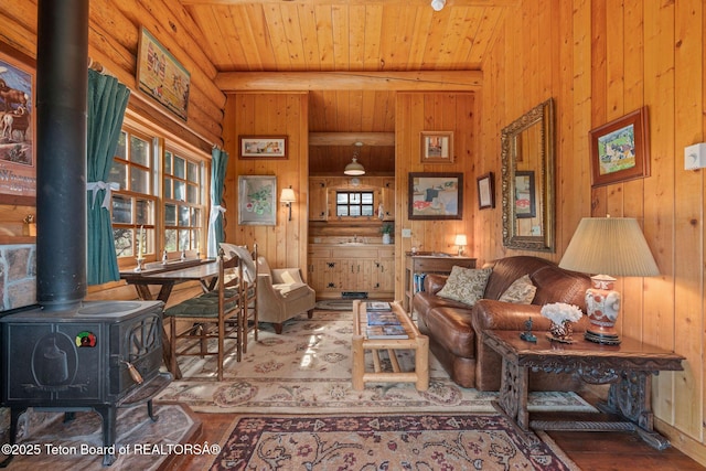 53 Schenck Ln, Dubois, WY 82513 - living area with wood finished floors, wooden walls, a wood stove, and a wood ceiling with exposed beams