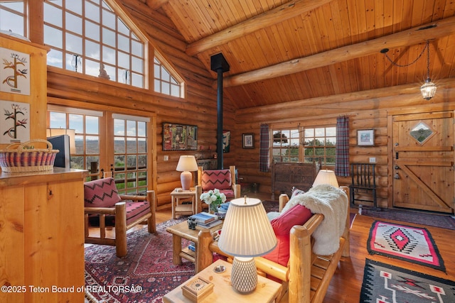 53 Schenck Ln, Dubois, WY 82513 - living area with log walls, a wooden ceiling with exposed beams, wood finished floors, high vaulted ceiling, and french doors