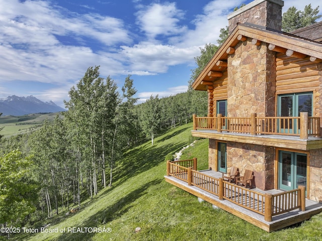 1520 N Pratt Rd, Jackson, WY 83001 - view of green lawn featuring a balcony and a deck with mountain view
