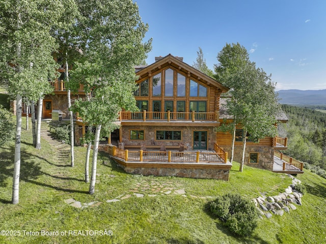 1520 N Pratt Rd, Jackson, WY 83001 - back of house with a lawn, stone siding, a deck, and a balcony