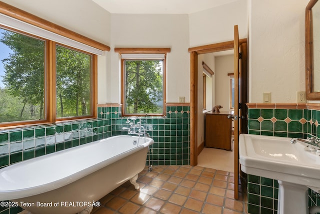 1520 N Pratt Rd, Jackson, WY 83001 - bathroom with a freestanding bath, tile walls, wainscoting, and tile patterned flooring
