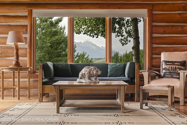 1520 N Pratt Rd, Jackson, WY 83001 - living room with log walls, a mountain view, and wood finished floors