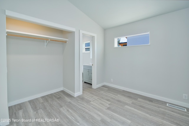 436 E Little Ave, Driggs, ID 83422 - unfurnished bedroom with light wood-style floors, vaulted ceiling, a closet, and ensuite bath