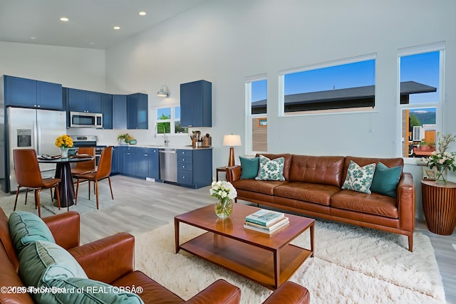 436 E Little Ave, Driggs, ID 83422 - living room with light wood-style floors, high vaulted ceiling, and recessed lighting