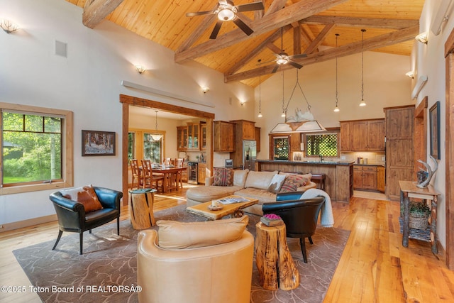 445 Aspen Ridge Trl, Alpine, WY 83128 - living area with high vaulted ceiling, ceiling fan, a wood ceiling with exposed beams, light wood-style flooring, and beverage cooler