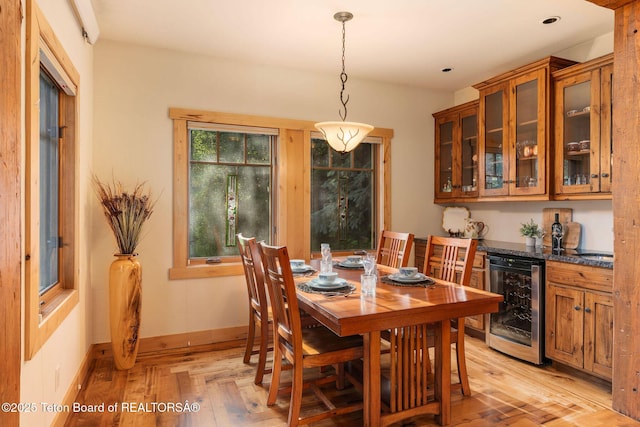 445 Aspen Ridge Trl, Alpine, WY 83128 - dining area with beverage cooler and light wood-style floors
