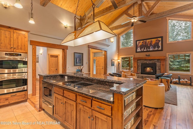 445 Aspen Ridge Trl, Alpine, WY 83128 - kitchen with appliances with stainless steel finishes, a wooden ceiling with exposed beams, open shelves, high vaulted ceiling, and a warming drawer
