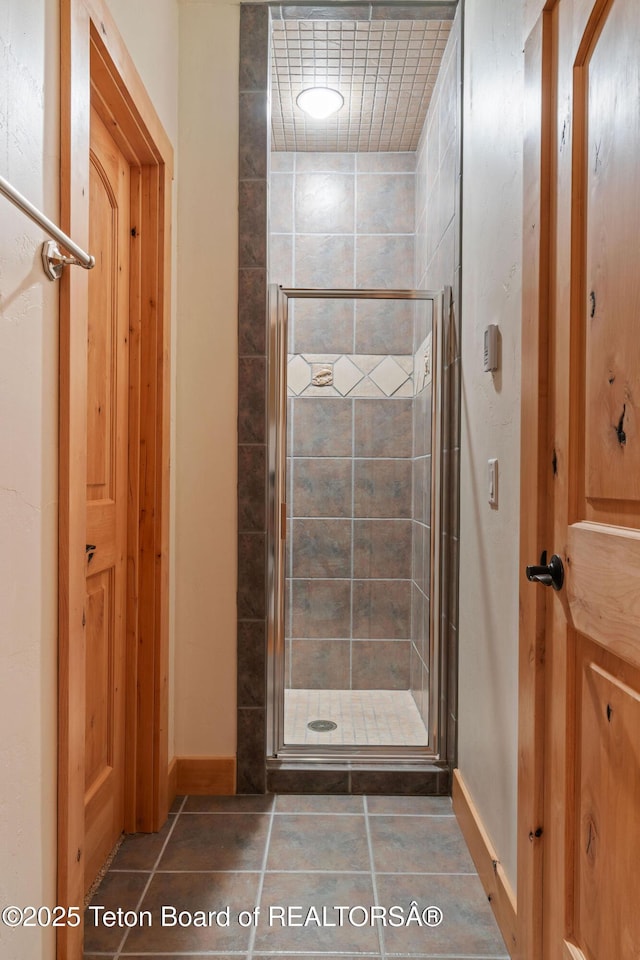 445 Aspen Ridge Trl, Alpine, WY 83128 - full bathroom featuring a stall shower and tile patterned flooring