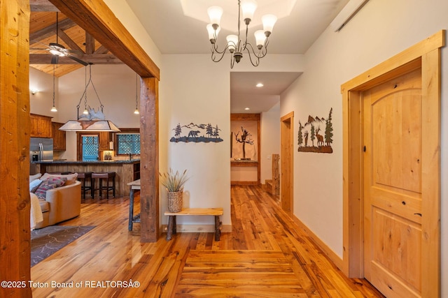 445 Aspen Ridge Trl, Alpine, WY 83128 - hallway with light wood finished floors, a chandelier, and recessed lighting