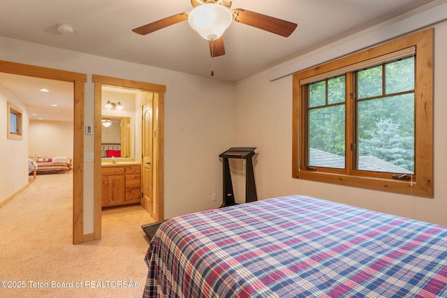 445 Aspen Ridge Trl, Alpine, WY 83128 - bedroom with light carpet, ensuite bathroom, and recessed lighting