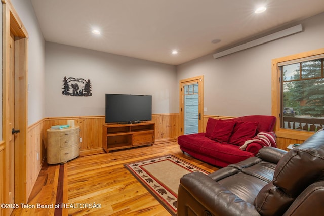 445 Aspen Ridge Trl, Alpine, WY 83128 - living area featuring a wainscoted wall, light wood finished floors, wooden walls, and recessed lighting