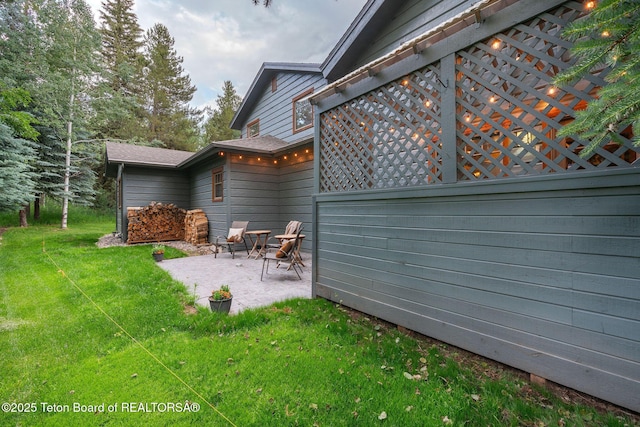 445 Aspen Ridge Trl, Alpine, WY 83128 - view of green lawn featuring a patio