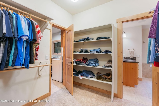 445 Aspen Ridge Trl, Alpine, WY 83128 - spacious closet featuring washer / clothes dryer and light carpet