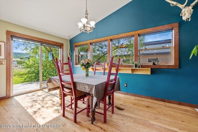 172 Brome Dr, Victor, ID 83455 - dining area with a chandelier, wood finished floors, and vaulted ceiling