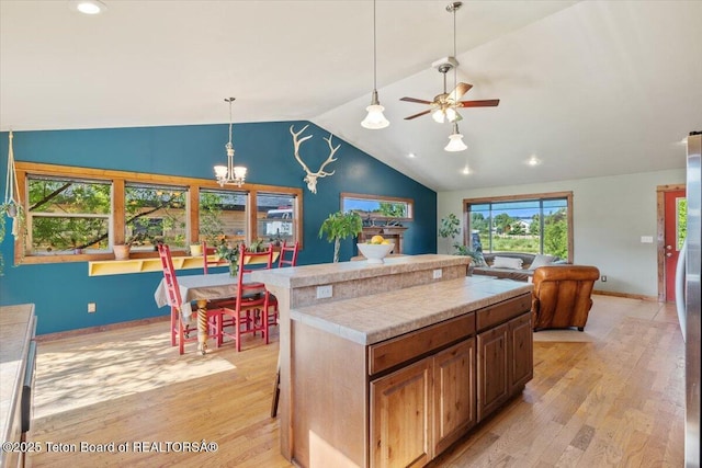 172 Brome Dr, Victor, ID 83455 - kitchen featuring light wood-type flooring, vaulted ceiling, ceiling fan, a chandelier, and recessed lighting