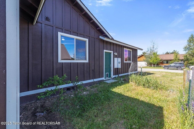 172 Brome Dr, Victor, ID 83455 - view of side of home with board and batten siding and a lawn