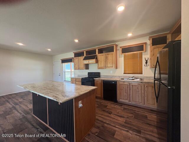47 Jackalope Dr, Irwin, ID 83428 - kitchen featuring black appliances, a center island, ventilation hood, dark wood-style floors, and light brown cabinetry