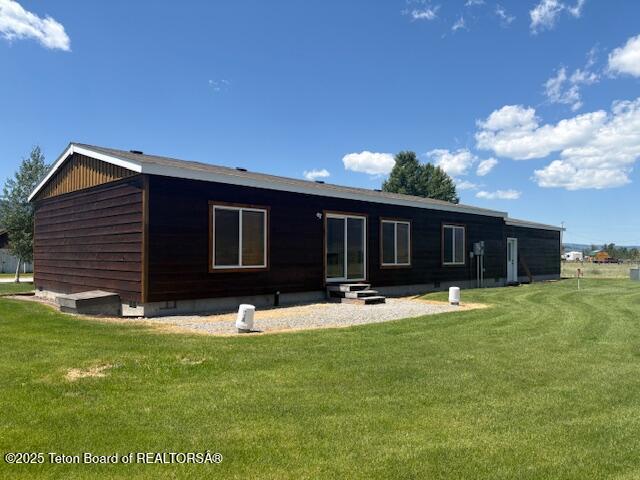 47 Jackalope Dr, Irwin, ID 83428 - back of property featuring a lawn and entry steps