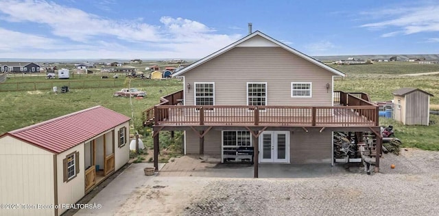 25 Neosha Trl, Boulder, WY 82923 - back of house featuring a patio, a wooden deck, french doors, a yard, and a storage shed