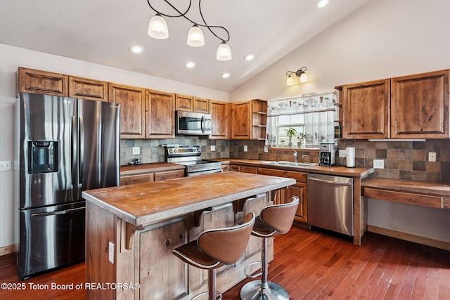 25 Neosha Trl, Boulder, WY 82923 - kitchen featuring appliances with stainless steel finishes, open shelves, a kitchen island, brown cabinets, and recessed lighting