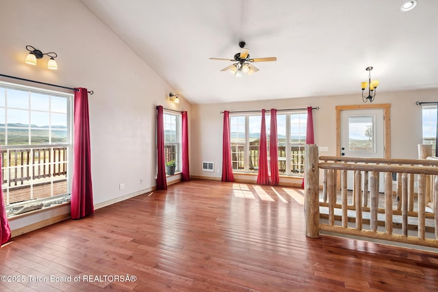 25 Neosha Trl, Boulder, WY 82923 - unfurnished living room featuring a ceiling fan, hardwood / wood-style flooring, vaulted ceiling, and healthy amount of natural light