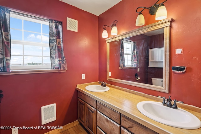 25 Neosha Trl, Boulder, WY 82923 - bathroom featuring heating unit, double vanity, and wood finished floors