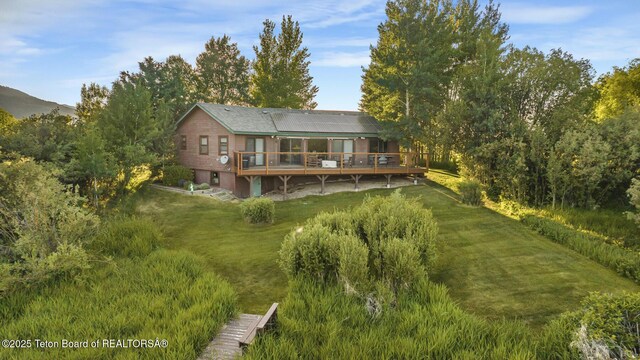 3953 Adams Rd, Driggs, ID 83422 - back of property featuring a wooden deck and a yard