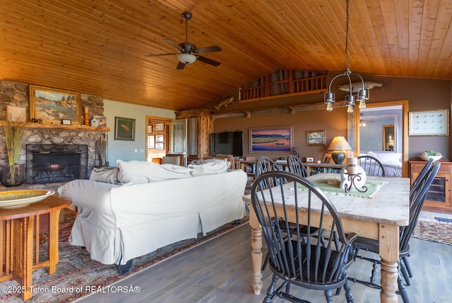 3953 Adams Rd, Driggs, ID 83422 - dining space featuring a ceiling fan, vaulted ceiling, wood ceiling, dark wood-style flooring, and a fireplace