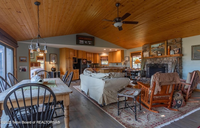 3953 Adams Rd, Driggs, ID 83422 - living area featuring lofted ceiling, dark wood-style flooring, a ceiling fan, wooden ceiling, and a stone fireplace