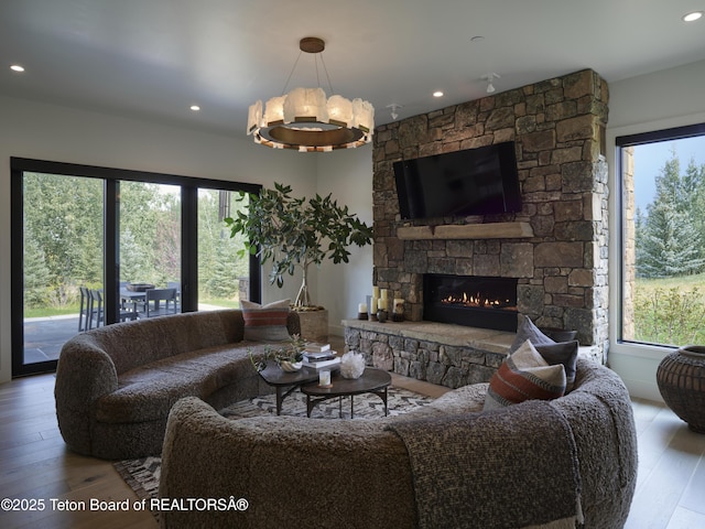 5060 W Eagle Rd, Wilson, WY 83014 - living room with healthy amount of natural light, wood-type flooring, recessed lighting, and a stone fireplace