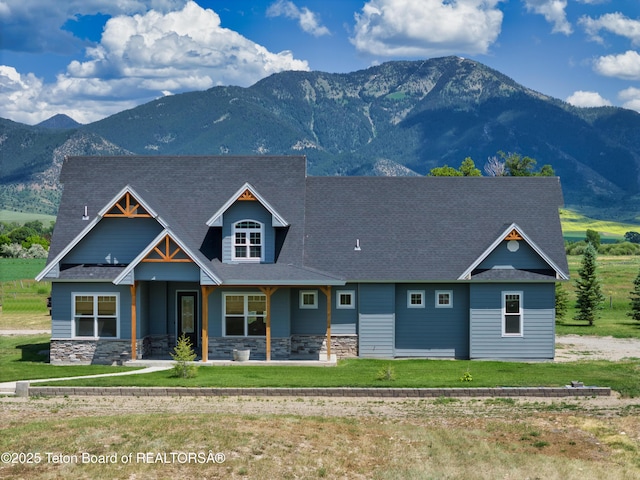 3139 Swan Valley Hwy, Swan Valley, ID 83449 - view of front of house featuring a mountain view, stone siding, and a front lawn