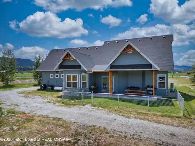 3139 Swan Valley Hwy, Swan Valley, ID 83449 - rear view of property with a mountain view, a shingled roof, and dirt driveway
