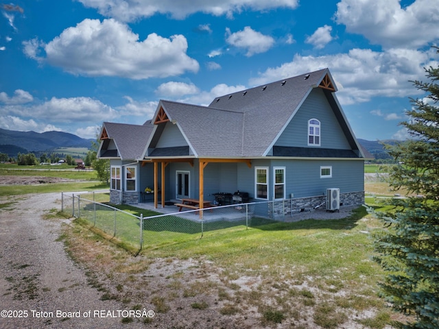 3139 Swan Valley Hwy, Swan Valley, ID 83449 - back of house featuring a patio, a fenced backyard, a mountain view, and a shingled roof