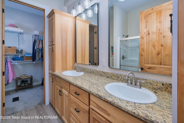 3139 Swan Valley Hwy, Swan Valley, ID 83449 - full bath with double vanity, wood finished floors, a spacious closet, and an enclosed shower