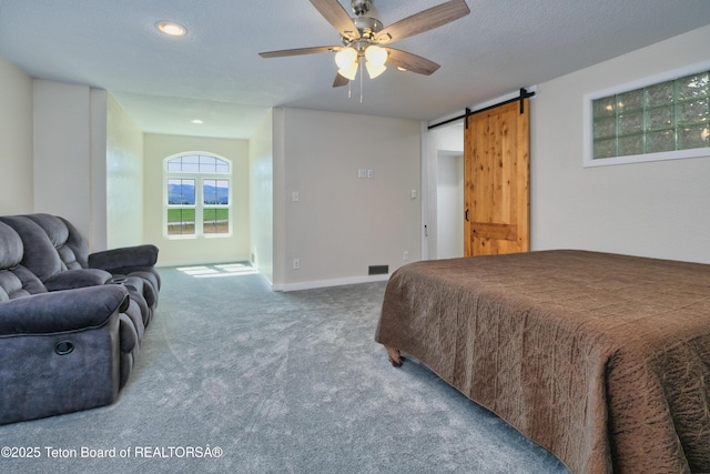 3139 Swan Valley Hwy, Swan Valley, ID 83449 - bedroom featuring a barn door, carpet, and ceiling fan