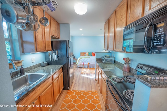 200 Homestead Rd Unit 309, Victor, ID 83455 - kitchen featuring black appliances, brown cabinets, recessed lighting, and light tile patterned floors